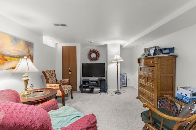 living area featuring carpet floors and visible vents