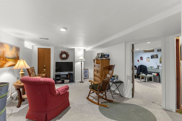 living area featuring carpet flooring and visible vents