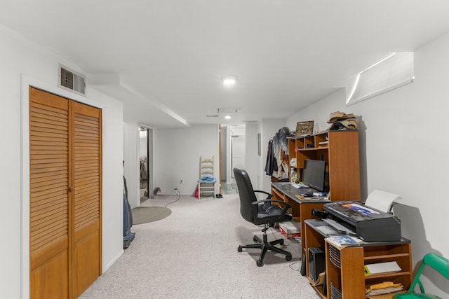 carpeted office with visible vents and baseboards