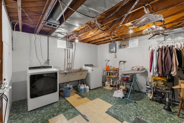 laundry area with laundry area, a sink, electric panel, tile patterned floors, and washer and clothes dryer