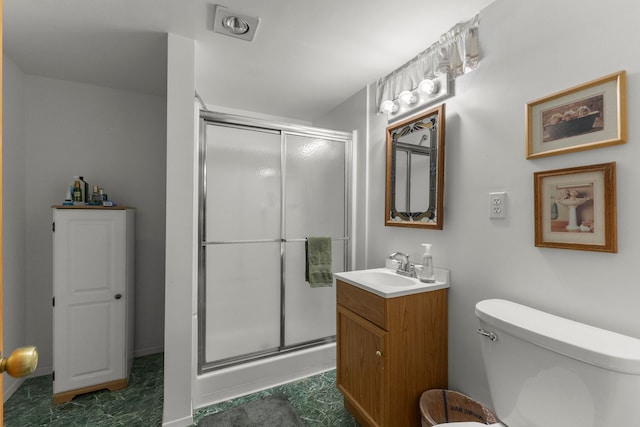 bathroom featuring a shower stall, toilet, and vanity