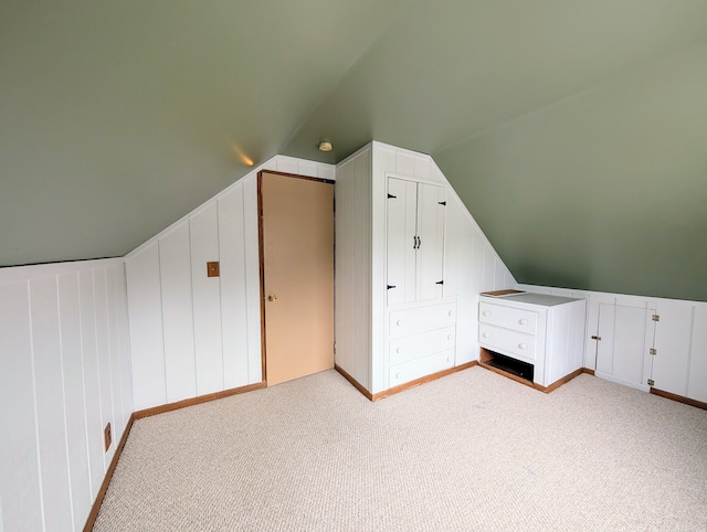 bonus room featuring vaulted ceiling and carpet floors