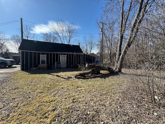 view of front of house featuring a sunroom and a front yard