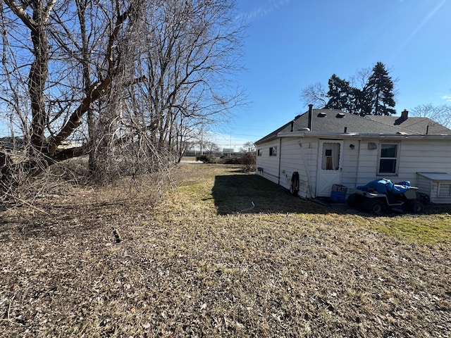 view of property exterior with a lawn