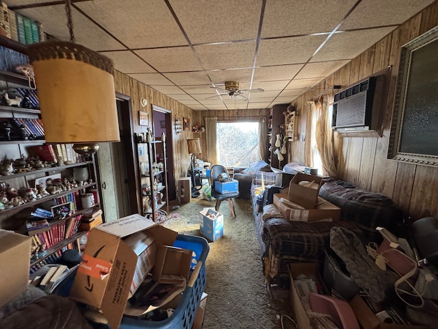 miscellaneous room with carpet floors, a wall mounted AC, a paneled ceiling, and wooden walls