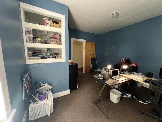 carpeted home office featuring baseboards