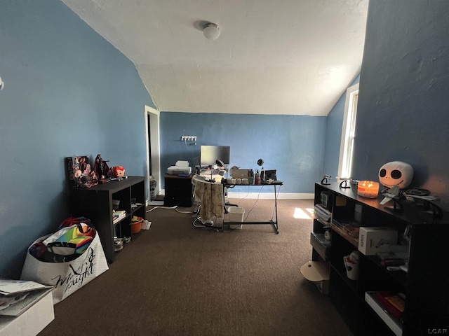 office space featuring lofted ceiling, carpet flooring, and baseboards