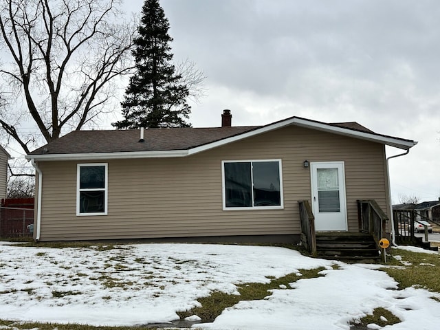 view of front of home featuring a chimney