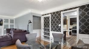 dining room featuring ornamental molding and wood finished floors