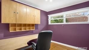 office area with baseboards and wood finished floors