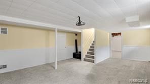 finished basement with visible vents and stairway