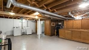 unfinished basement featuring washing machine and clothes dryer