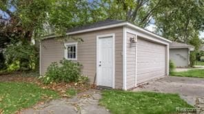 view of outdoor structure with aphalt driveway and an outbuilding