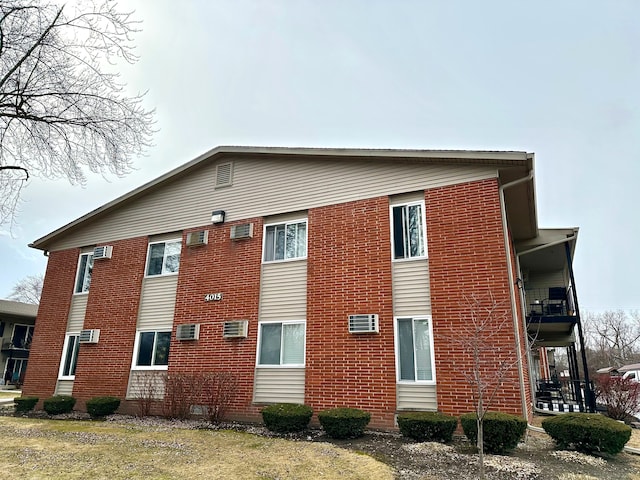 view of side of home with brick siding