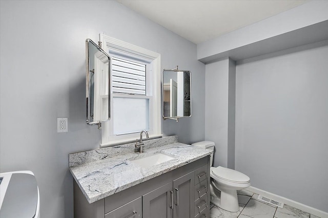 half bath featuring visible vents, baseboards, toilet, marble finish floor, and vanity