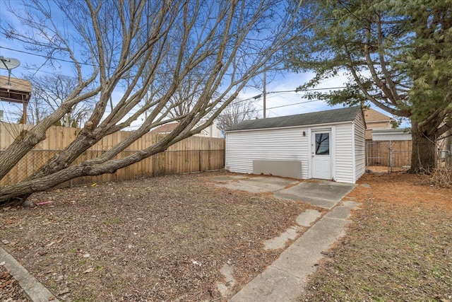 view of yard with a fenced backyard and an outbuilding