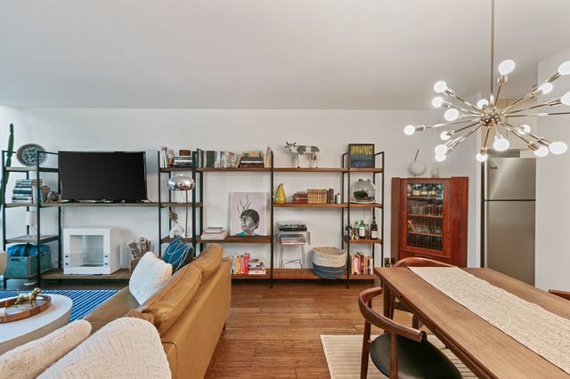 interior space featuring an inviting chandelier and wood finished floors