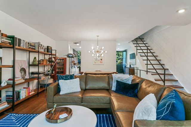 living area with stairway, recessed lighting, wood finished floors, and an inviting chandelier