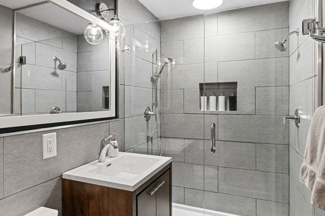 bathroom featuring a shower stall and vanity