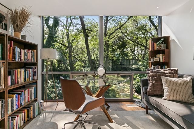 living area with expansive windows and wood finished floors