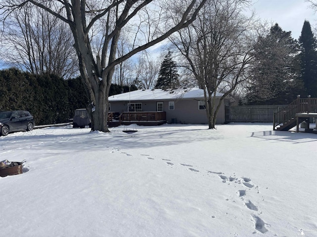 snowy yard featuring a deck