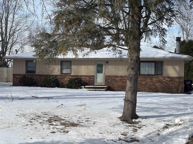 single story home with brick siding and board and batten siding