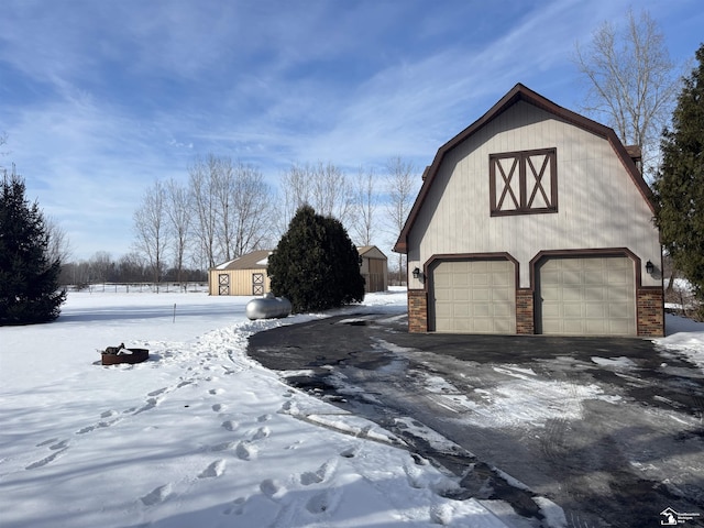 snow covered garage featuring a garage