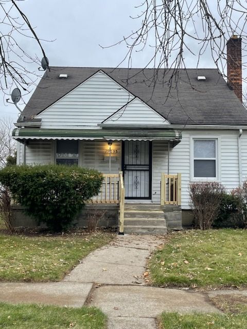 bungalow-style home with a chimney, a front lawn, and a porch