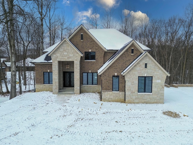 view of front of home featuring brick siding and stone siding