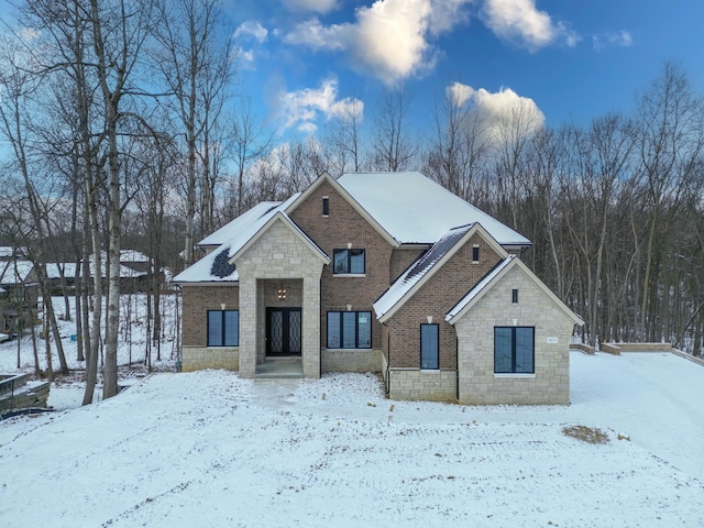 view of front of house featuring stone siding and brick siding