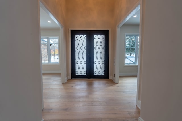 entrance foyer featuring recessed lighting, french doors, baseboards, and light wood-style flooring