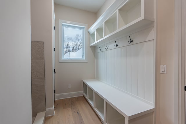 mudroom featuring light wood-style flooring and baseboards