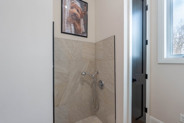 full bathroom with a tile shower