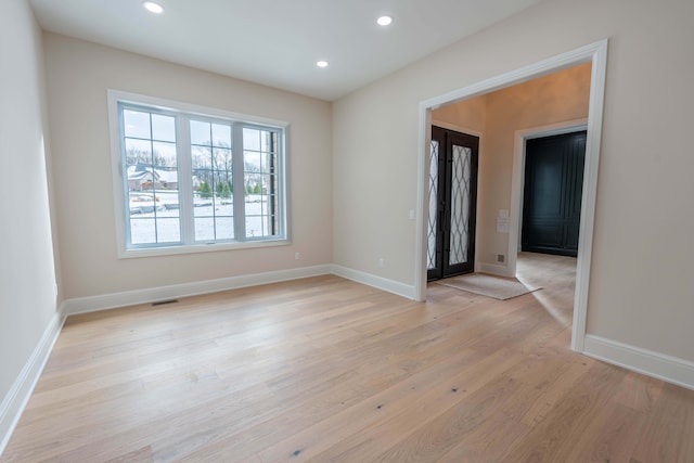 empty room featuring recessed lighting, visible vents, baseboards, and light wood-style flooring