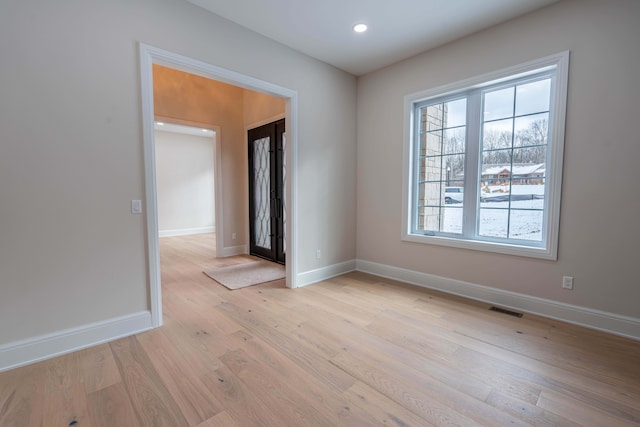 unfurnished room featuring visible vents, recessed lighting, baseboards, and light wood-type flooring