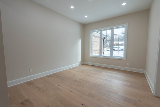 empty room featuring recessed lighting, light wood-style flooring, visible vents, and baseboards