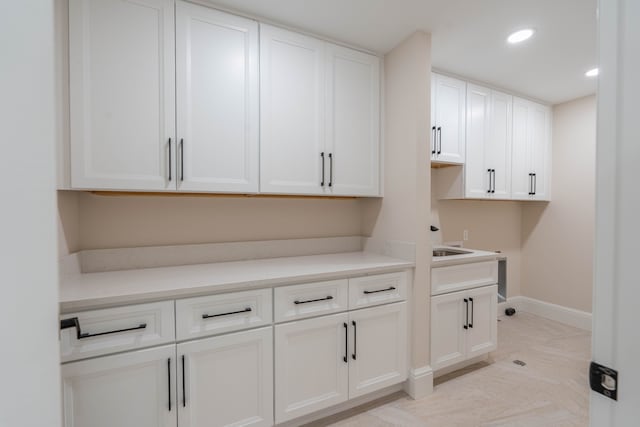 clothes washing area with recessed lighting, cabinet space, hookup for a washing machine, and baseboards