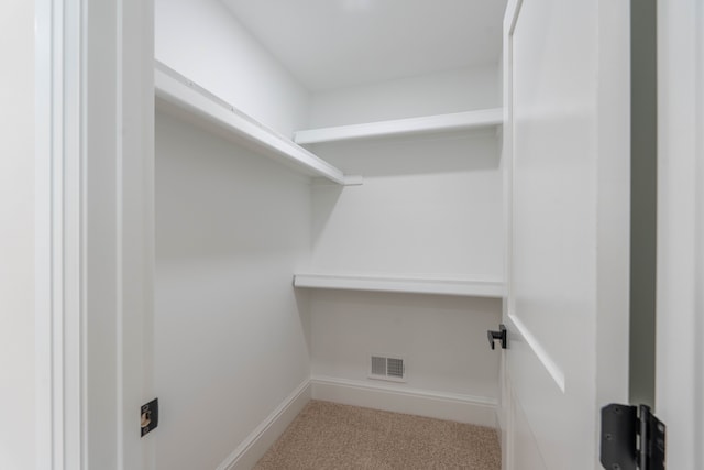 spacious closet featuring carpet and visible vents