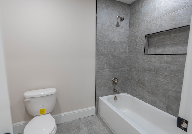 full bath featuring baseboards, toilet, and washtub / shower combination