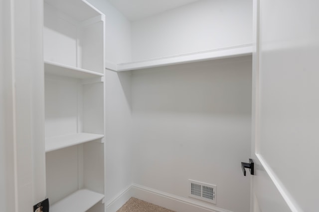 spacious closet featuring visible vents