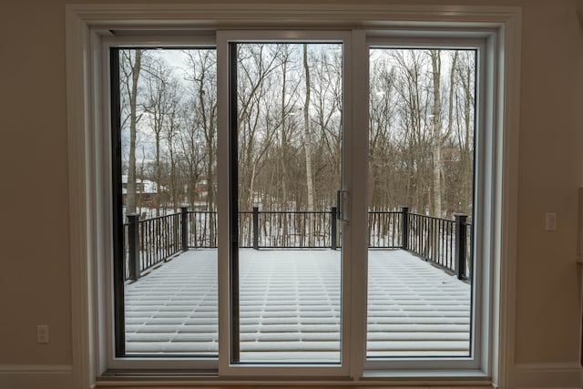 doorway to outside with baseboards