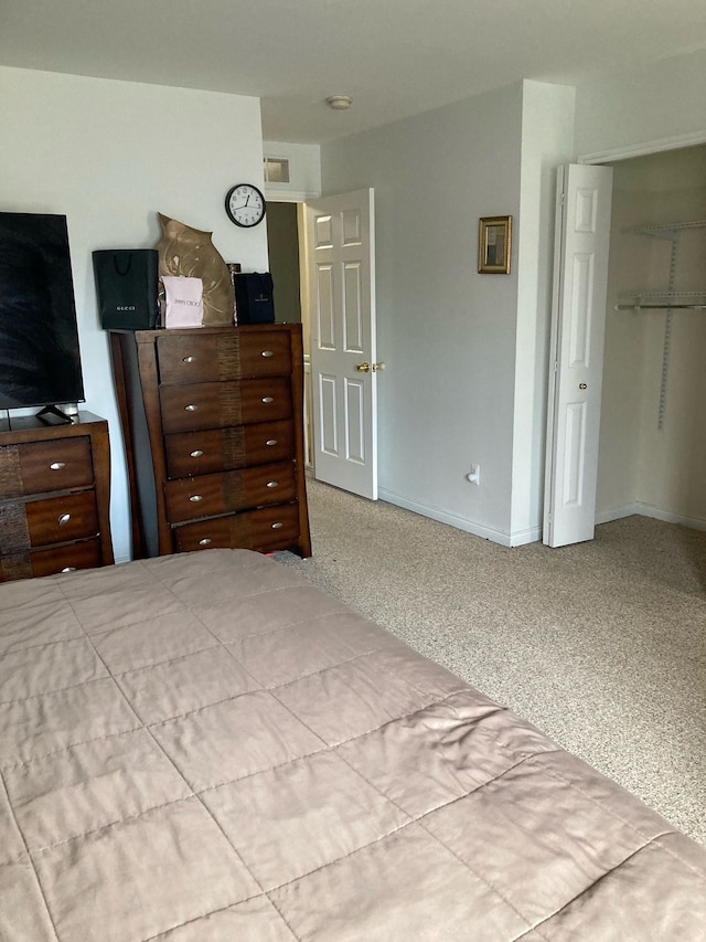 unfurnished bedroom featuring carpet floors, visible vents, and baseboards