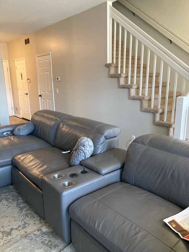 living room with stairs and visible vents