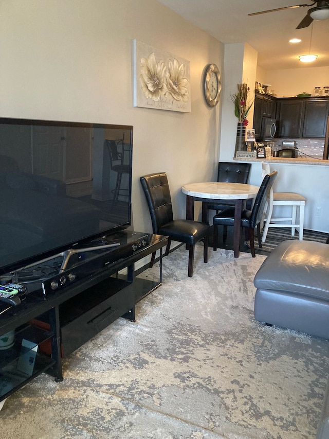 carpeted dining area featuring ceiling fan