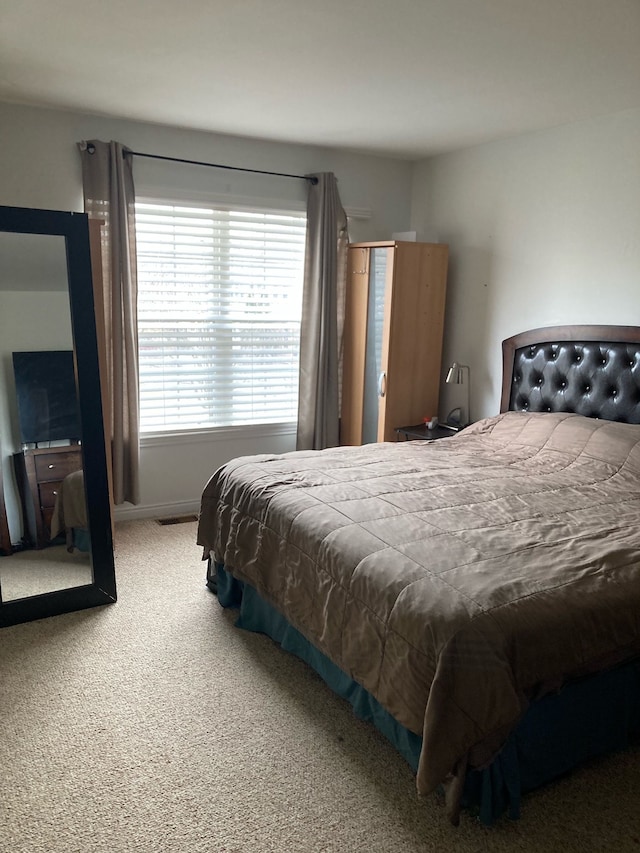 bedroom featuring carpet flooring and baseboards