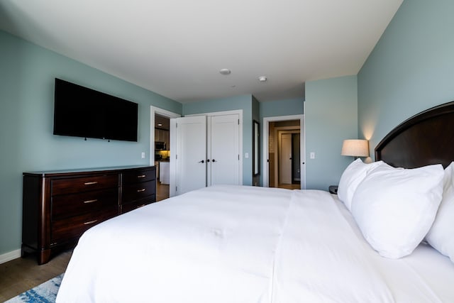 bedroom with baseboards and wood finished floors