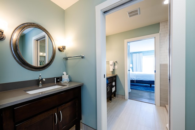 full bath featuring baseboards, visible vents, ensuite bathroom, and vanity