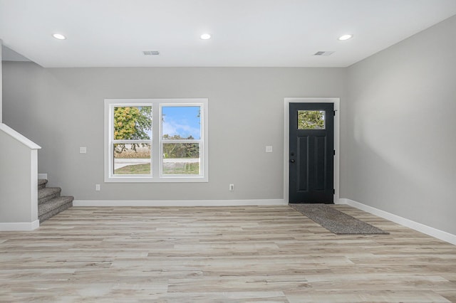 foyer with visible vents, stairway, and baseboards