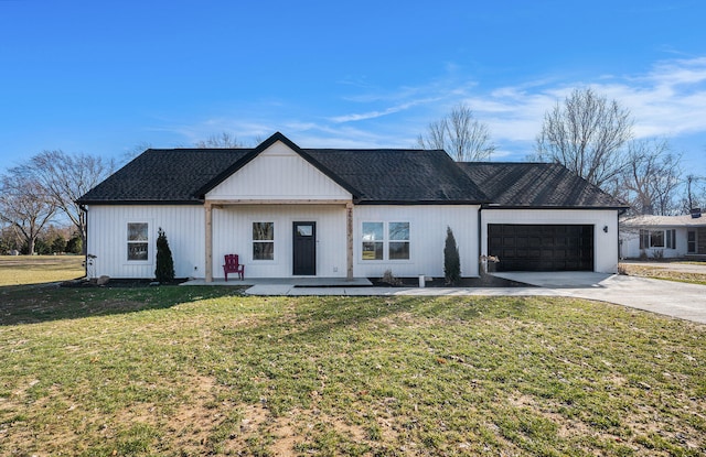 modern farmhouse with a garage, driveway, a shingled roof, and a front lawn