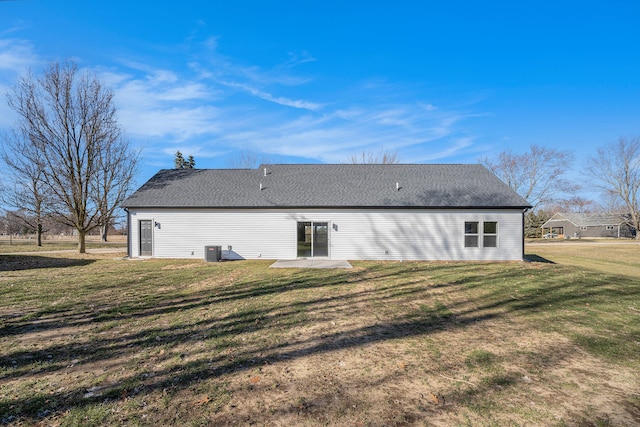 back of house with a shingled roof, a patio area, a lawn, and central AC unit